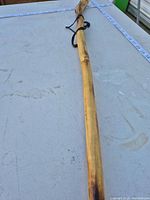 Full view of wooden walking stick on table