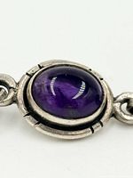 close-up of one amethyst cabochon bezel link