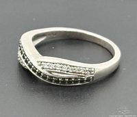 Ring three-quarter view showing twist design and diamond rows