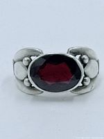 Front view showing oval garnet and decorative silver band