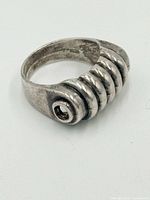 Top and side view of sterling silver ring showing ribbed design and eyelet shoulder