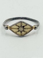 Front view of sterling silver signet ring showing diamond shape and starburst design