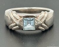 Front view showing princess-cut topaz in bypass setting