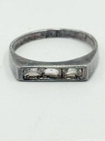 Front view showing three clear stones in channel setting on rectangular face