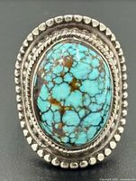 Front view showing turquoise cabochon and beaded sterling silver setting