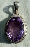 Front view showing faceted amethyst and rope edge bezel