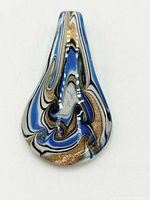 Front view of pendant showing swirl pattern and gold flecks