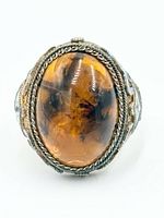 front view showing amber cabochon and filigree bezel