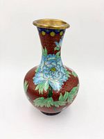 Front view showing blue peony, foliage and brass rim