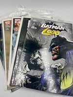 Stack of five bagged comics with Batman/Lobo on top, others partially visible