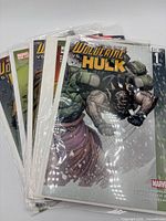 Stack of six bagged Marvel comic books, top showing Ultimate Wolverine Vs Hulk