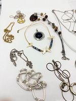 Overview of necklaces, pendants, chains and earrings on white background