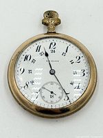 Front view of pocket watch showing dial, branding, numerals, sub-seconds dial