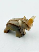 Side view of carved stone elephant figurine