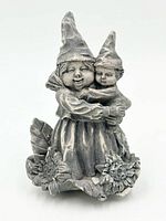 Front view of grey gnome figurine showing adult and child gnomes with sunflower base