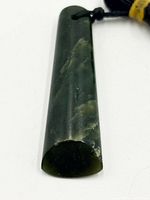 Front view of greenstone pendant displaying color and veining