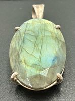 Front view of oval labradorite cabochon in silver prong setting