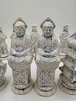 Front view of seated king and queen pieces