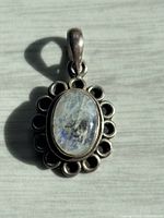 front view showing moonstone and scalloped bezel