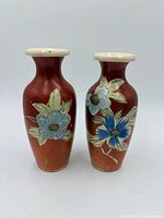 Front view of both ceramic vases showing floral design