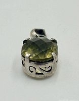 Front view of oval faceted peridot in sterling silver prong setting