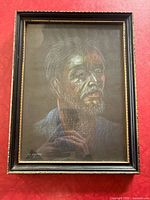 Frontal view of framed pastel portrait