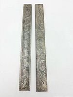 Front view showing dragon engravings on both scroll weights