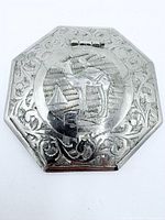 Top view showing engraved stag scene and overall octagonal form