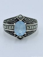 Front view of sterling silver ring showing blue topaz and marcasite detailing