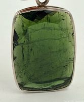 Front view of pendant showing green tourmaline and bezel setting