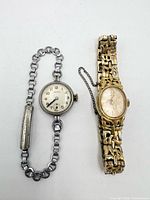Front view of both watches showing dial styles and bracelet designs