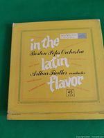 Front of yellow box showing title, orchestra, conductor, 45 RPM designation