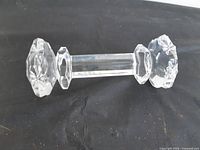 clear faceted glass knife/utensil rest on dark background