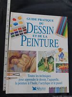 Front cover showing title, artwork, ruler for scale