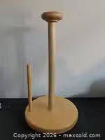 Front view of pine wood paper towel holder showing base, central dowel, side tear bar and knob