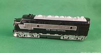 Left side view of black/silver New York Central locomotive