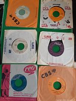 Six 7-inch singles in various company sleeves laid out