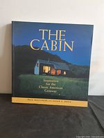 Front cover showing title, authors and cabin image