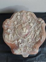 Top view of Incolay stone jewelry box showing cherub relief and coloration