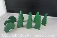 Group of green wooden trees and bushes on white surface