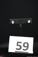 pair of oval stud earrings on display stand