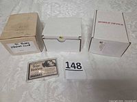 Overview showing three card storage boxes and one lucite-cased card