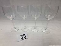 Four wine glasses standing in a row
