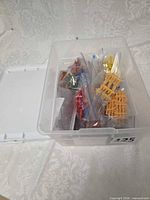 bin with lid and bagged figures