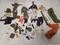 Lot laid out showing figures, uniforms, weapons, gear