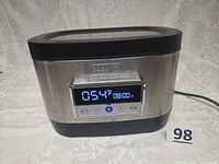 Front view showing stainless body, digital display and branding