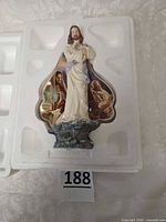 Statue in molded styrofoam packaging, front view showing overall design and COA compartment