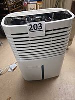 Front view of Hisense dehumidifier showing grille, control panel, overall condition