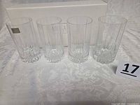Four Mikasa Arctic Lights crystal highball glasses in front of original box