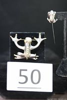 Front view of both frog jewellery pieces displayed upright